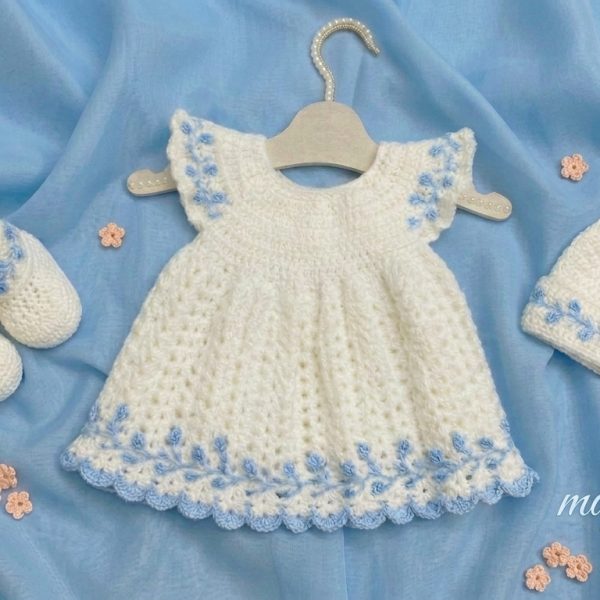 White crochet baby dress with sky blue embroidery, matching booties and cap