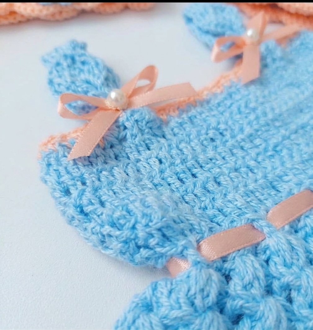 Sky blue crochet baby frock with peach flowers, pearls and satin ribbon