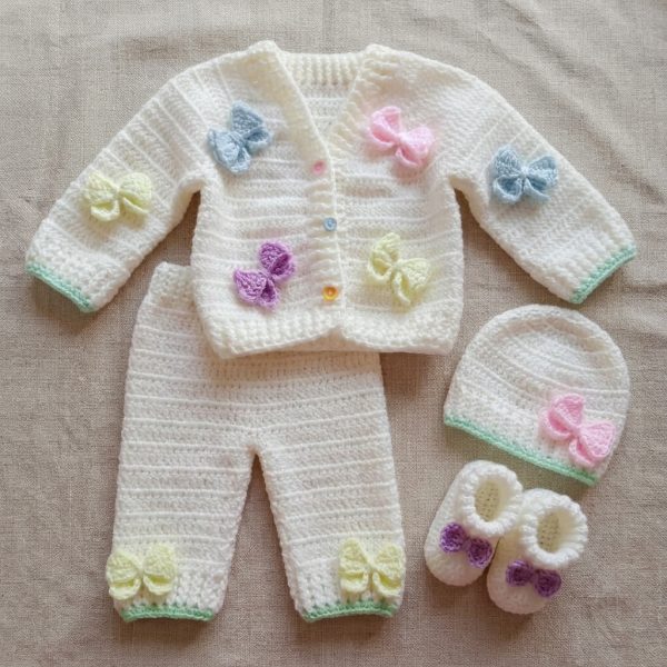 Off-white crochet baby set with pastel bows: cardigan, trousers, cap and booties