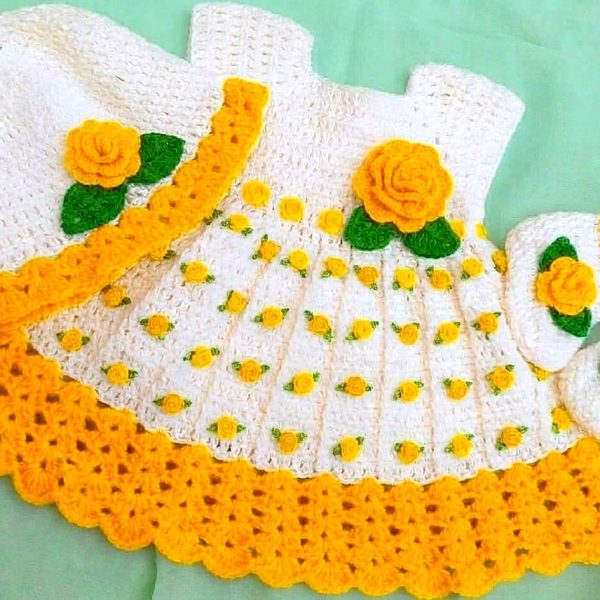 Yellow and white crochet baby dress with flowers