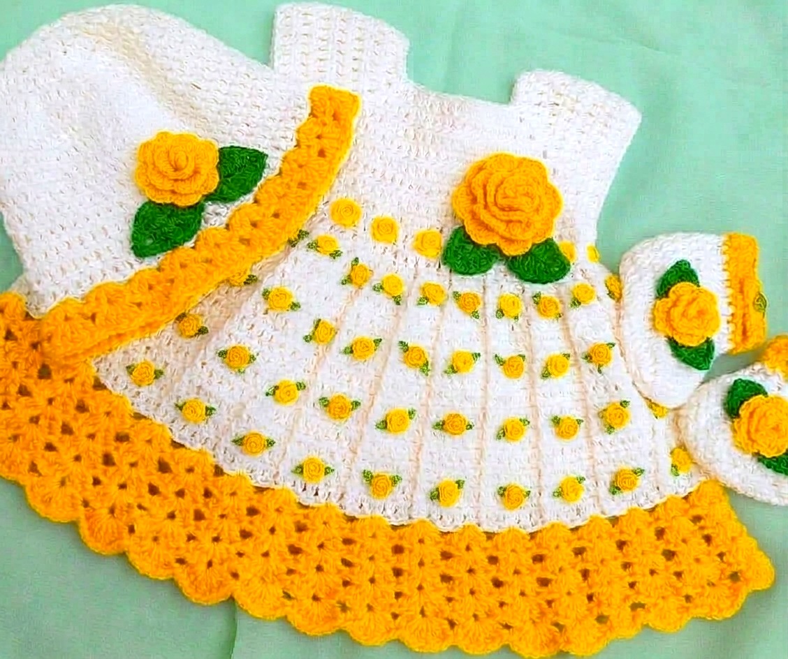 Yellow and white crochet baby dress with flowers