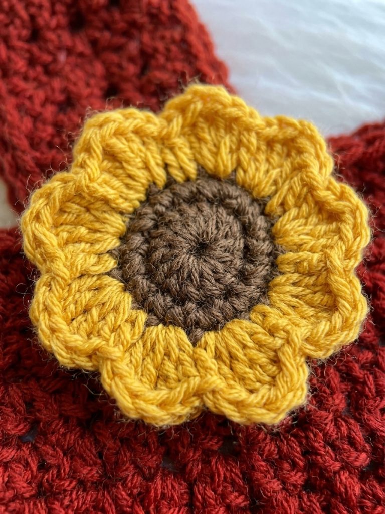 Close-up of a yellow crochet sunflower